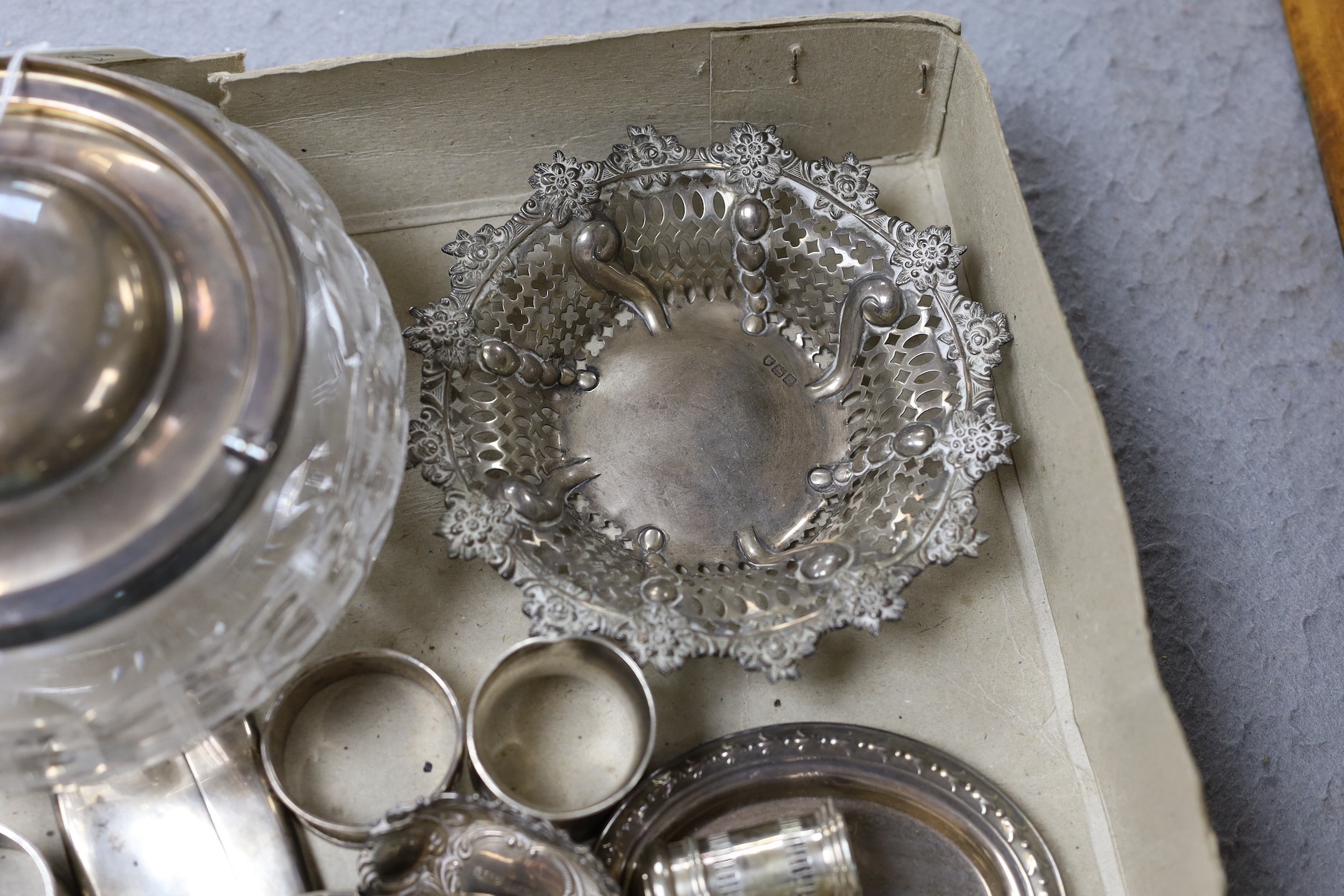 A George V silver mounted glass bowl and cover and other sundry silver including napkin rings, vesta case and condiments.